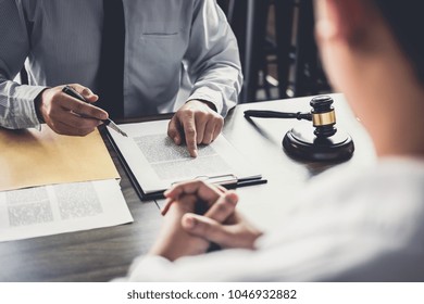 Businessman And Male Lawyer Or Judge Consult Having Team Meeting With Client, Law And Legal Services Concept.