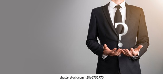 Businessman Man Hand Hold Interface Question Marks Sign Web. Ask Quiestion Online, FAQ Concept, What Where When How And Why, Search Information On Internet.