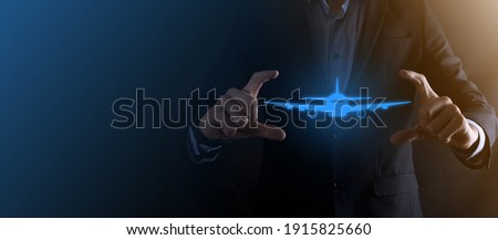 Businessman man holding an airplane icon in his hands. Online ticket purchase.Travel