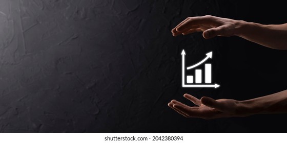 Businessman man holding a graph with positive profits growth. plan graph growth and increase of chart positive indicators in his business.more profitable and growing - Shutterstock ID 2042380394