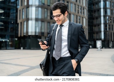 A Businessman Man Uses A Phone In His Hands Writes A Message Reply To A Colleague By Mail.