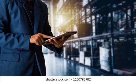Businessman manager using tablet check and control for workers with Modern Trade warehouse logistics. Industry 4.0 concept - Shutterstock ID 1150798982