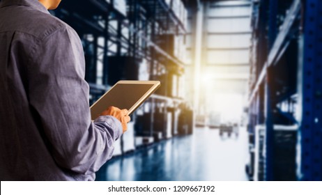 Businessman manager using tablet check and control for workers with Modern Trade warehouse global business commerce concept or import-export commercial logistic. Industry 4.0 concept