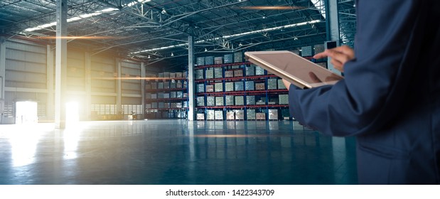 Businessman manager using tablet check and control for workers with Modern Trade warehouse logistics. Industry 5.0 concept - Powered by Shutterstock