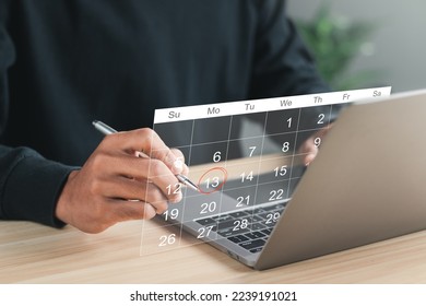 Businessman manages time for effective work. Calendar on the virtual screen interface. Highlight appointment reminders and meeting agenda on the calendar. Time management concept. - Shutterstock ID 2239191021
