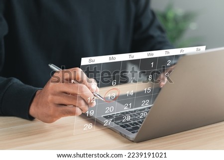Businessman manages time for effective work. Calendar on the virtual screen interface. Highlight appointment reminders and meeting agenda on the calendar. Time management concept.