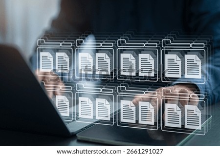 Businessman managing digital documents using virtual folder system on computer and tablet, representing cloud data storage, digital archive, and efficient document management in modern business.