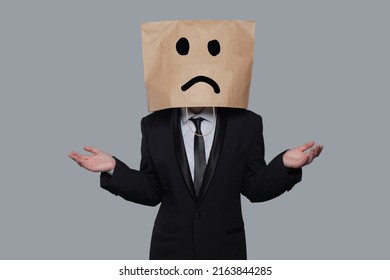 Businessman masked stress and doubt on gray banner background