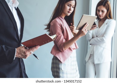 Businessman is in meeting discussion with colleague businesswomen in modern workplace office. People corporate business team concept. - Shutterstock ID 1345017152