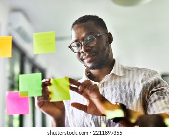 Businessman meeting at office and use post it notes to share idea. Brainstorming concept. Sticky note on glass wall. - Powered by Shutterstock