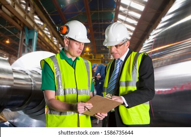 Businessman Meeting With Worker In Steel Mill - Powered by Shutterstock