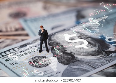 Businessman miniature figure standing on USD banknote with stock market chart graph for currency exchange of global trade forex and Fed increase interest rate to stop inflation concept. - Shutterstock ID 2259014407
