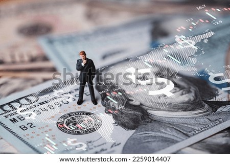 Businessman miniature figure standing on USD banknote with stock market chart graph for currency exchange of global trade forex and Fed increase interest rate to stop inflation concept.