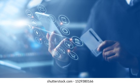 Businessman With Mobile Smartphone And Credit Card In Hand Paying Online And Shopping On Virtual Interface Global Network, Online Banking And Digital Marketing.