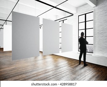 Businessman Modern Museum Expo Loft Interior.Open Space Studio.Empty White Canvas Hanging.Wood Floor,bricks Wall,panoramic Windows.Blank Frames Ready For Bussiness Information.Horizontal Mockup