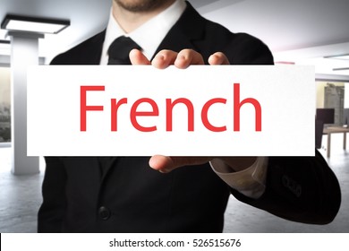 Businessman In Modern Office Holding Sign French