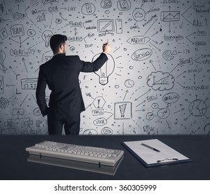 A Businessman In Modern Stylish Elegant Suit Standing On A Small Ladder And Drawing Pie And Block Charts On Grey Wall Background With Exponential Progressing Curves, Lines, Circles, Blocks, Numbers