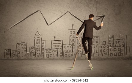A businessman in modern stylish elegant suit standing on a small ladder and drawing pie and block charts on grey wall background with exponential progressing curves, lines,  angles, blocks, numbers
