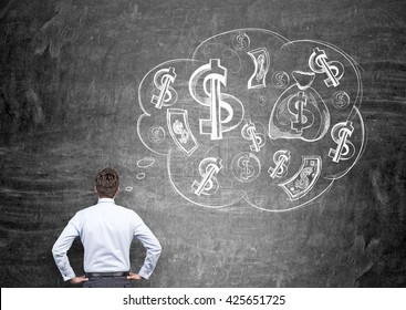 Businessman With Money On His Mind On Chalkboard Background