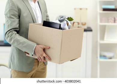 Businessman With Moving Box In Office