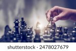 Businessman moving chess piece on chess board game concept for ideas and competition and strategy, business success concept, business competition planning teamwork strategic concept.	
