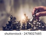 Businessman moving chess piece on chess board game concept for ideas and competition and strategy, business success concept, business competition planning teamwork strategic concept.	
