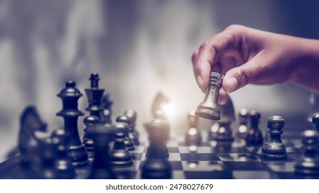 Businessman moving chess piece on chess board game concept for ideas and competition and strategy, business success concept, business competition planning teamwork strategic concept.	
