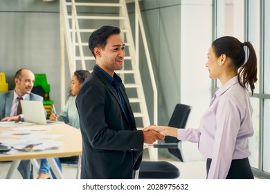 Businessman And New Employee Female Shake Hand In Meeting Room For Welcome To New Hiring Work