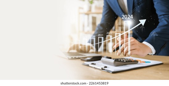 businessman new year business goals 2024, positive indicators 2024, positive indicators 2024, company competitiveness on global scale, businessman calculating financial data for long term investments. - Shutterstock ID 2261453819