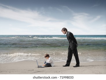 Businessman observing a child using a laptop
