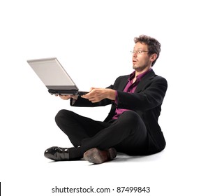 Businessman observing a laptop with astonished expression
