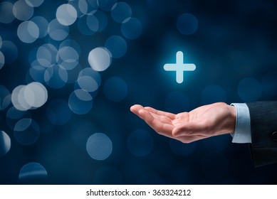 Businessman offer positive thing (like benefits, personal development, social networking) represented by plus sign, bokeh in background.