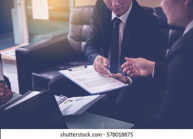 Businessman Offering Pen To His Business Partner For Sign Contract