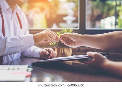 Businessman Offering Pen To His Business Partner For Sign Contract