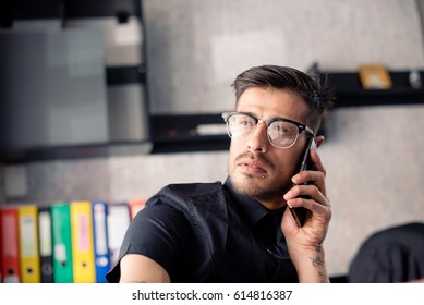 Businessman in office answering the phone,indoors - Shutterstock ID 614816387
