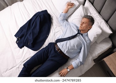 Businessman in office clothes sleeping on bed indoors, top view - Powered by Shutterstock