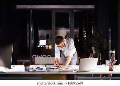 Businessman In The Office At Night Working Late.