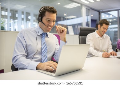 Businessman In The Office On The Phone With Headset, Skype,FaceTime