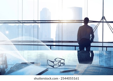 Businessman in office overlooking city skyline. Male businessman stands by window, contemplating cityscape. Office, businessman, business vision, goal and achievement concept with copy space. - Powered by Shutterstock