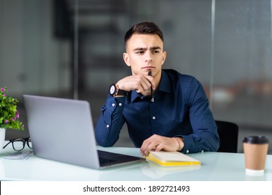 Businessman In Office Sitting At His Desk