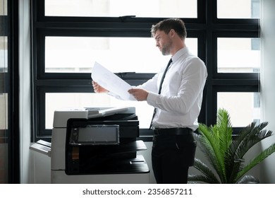 Businessman in office working with copier. - Powered by Shutterstock