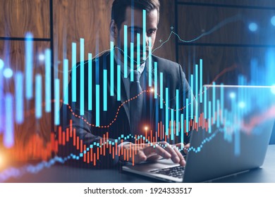 Businessman in office working with laptop technology forex online trading graph and chart, typing computer assemble data drawing concept. Double exposure.