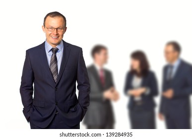 Businessman On Background Of Working People, Small Depth Of Field