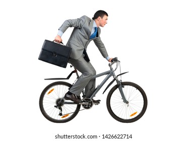 Businessman On Bike Hurry To Work. Young Man Scared To Be Late. Corporate Employee In Grey Business Suit With Suitcase Riding Bicycle. Male Cyclist Isolated On White Background. Rush Hour Concept