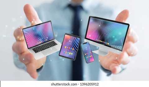 Businessman On Blurred Background Connecting Modern Smartphone Tablet Laptop And Computer