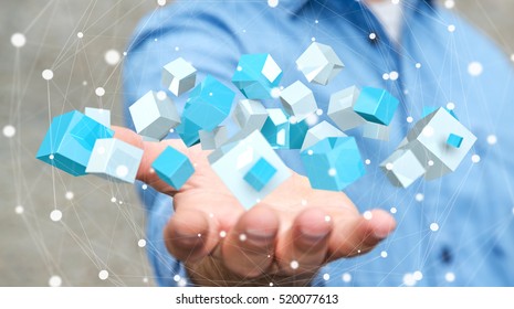 Businessman on blurred background holding flying blue shiny cube 3D rendering