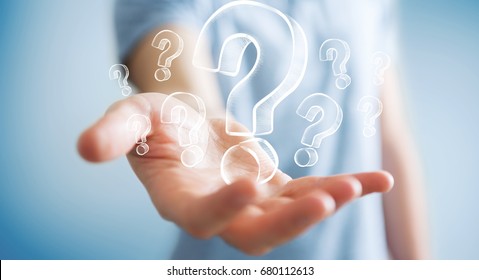 Businessman on blurred background holding hand drawn question marks - Shutterstock ID 680112613
