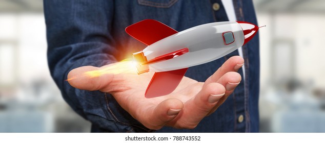Businessman on blurred background holding and touching a rocket 3D rendering