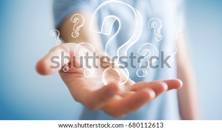 Businessman on blurred background holding hand drawn question marks