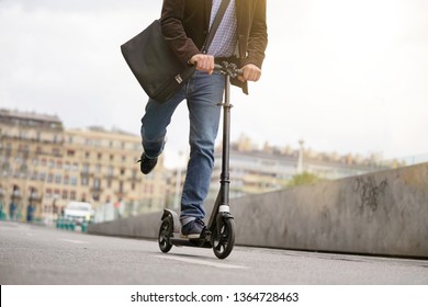 Businessman On Daily Commute Riding Micro Scooter